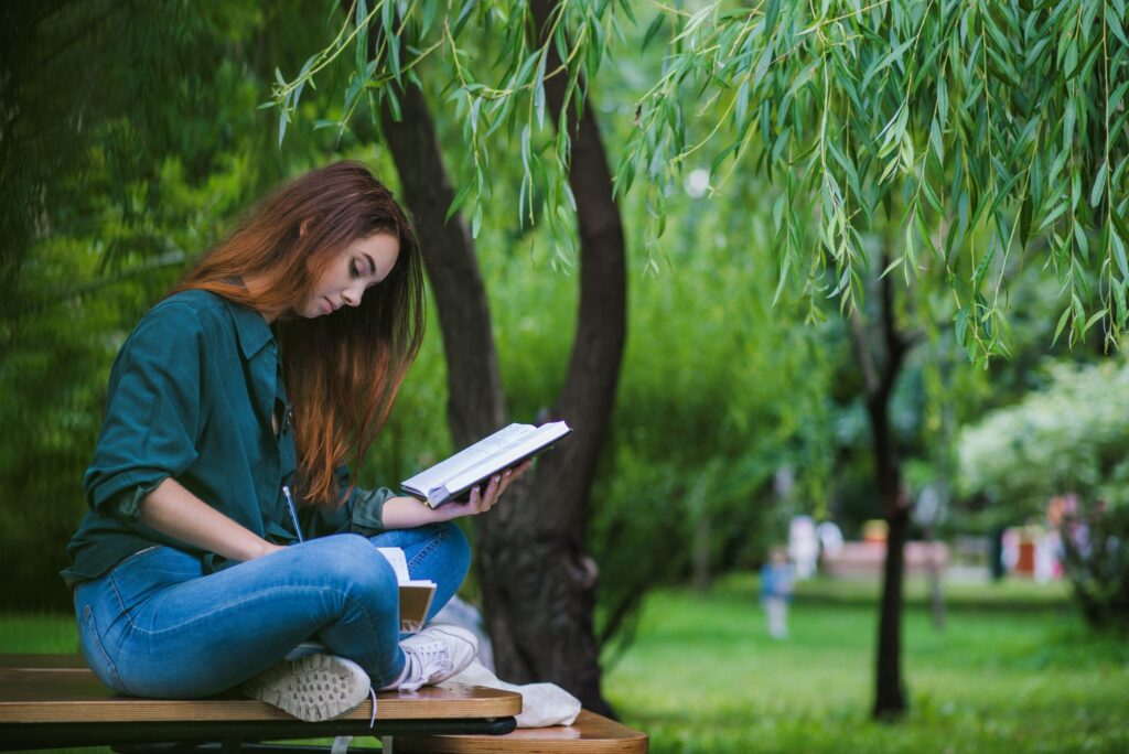 girl-sitting-table-park-writing2